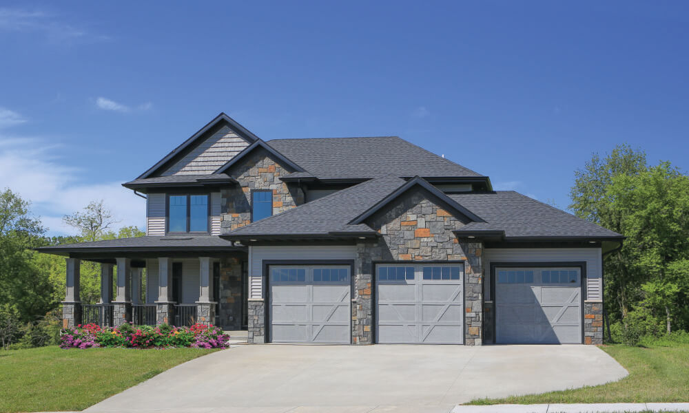 house with grey garage doors with v-lines on doors