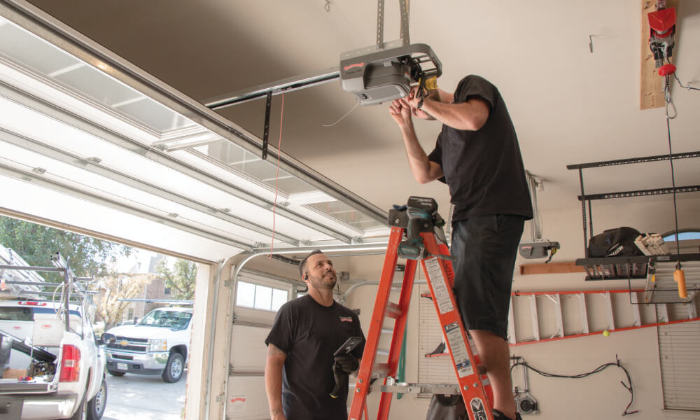 man on ladder in flathead valley montana servicing garage door opener